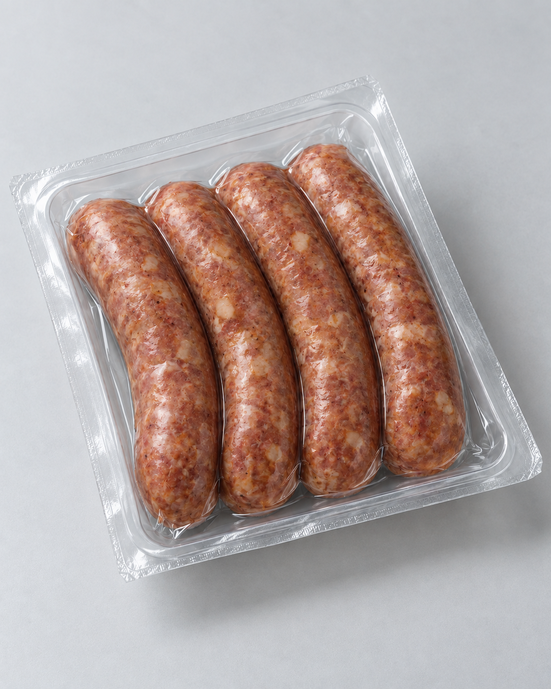 Studio-style image of sausages sealed in clear barrier film without labels