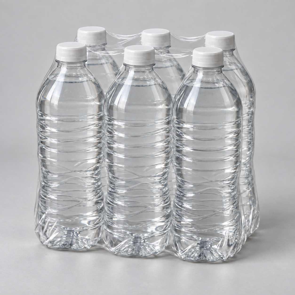 Unlabeled water bottles bundled in clear shrink film